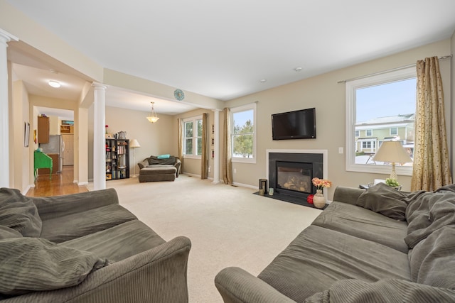 living room with carpet and ornate columns