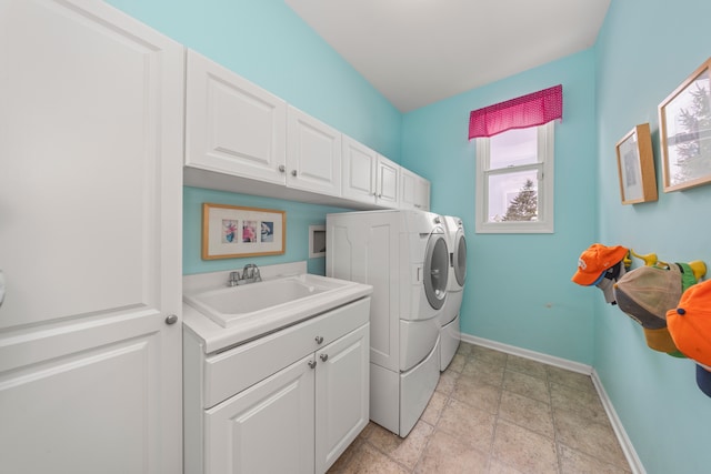 laundry room featuring sink, cabinets, and independent washer and dryer