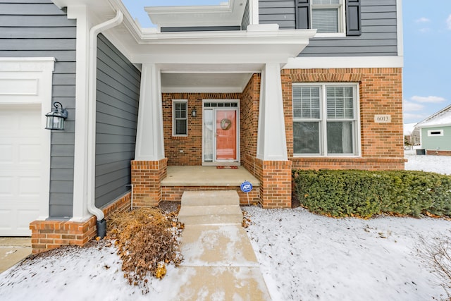 view of exterior entry with a garage