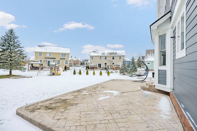 snow covered patio with a playground