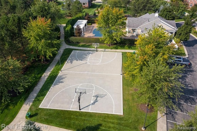 view of basketball court with a lawn