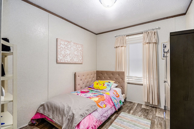 bedroom with ornamental molding, dark hardwood / wood-style flooring, and a textured ceiling