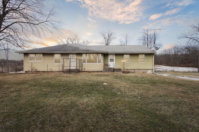 ranch-style house with a lawn