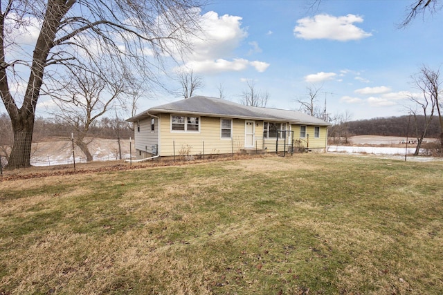 view of front of house featuring a front lawn and a water view