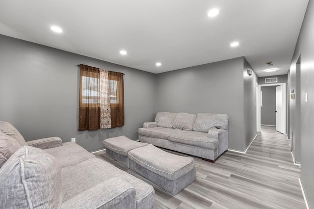 living room with light hardwood / wood-style flooring