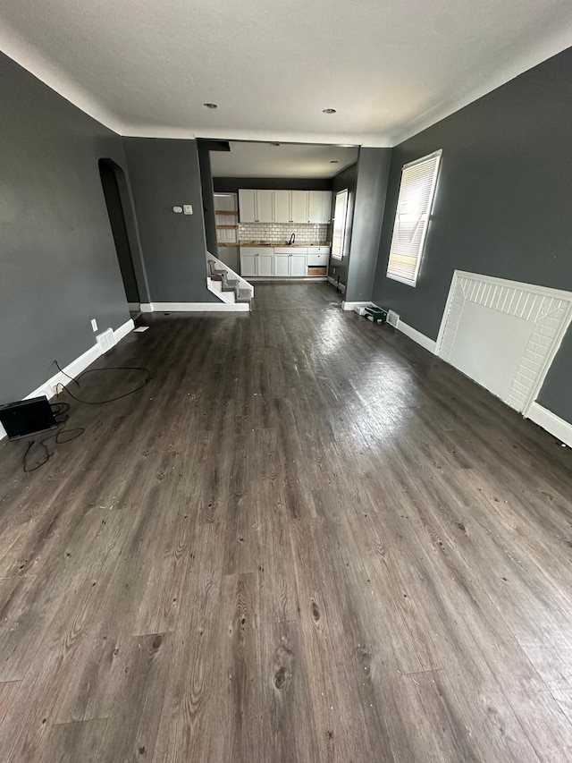 unfurnished living room with wood-type flooring