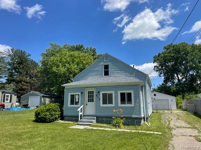 810 Moore St, Davison, MI 48423 - back of property featuring an outbuilding, entry steps, and a garage
