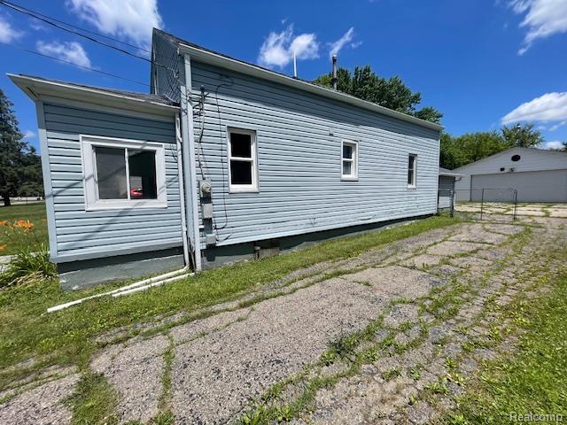 810 Moore St, Davison, MI 48423 - view of home's exterior with a garage