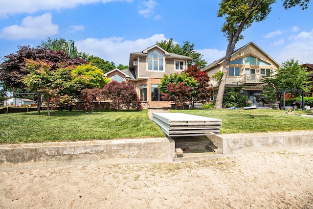 view of front of house featuring a balcony and a front lawn