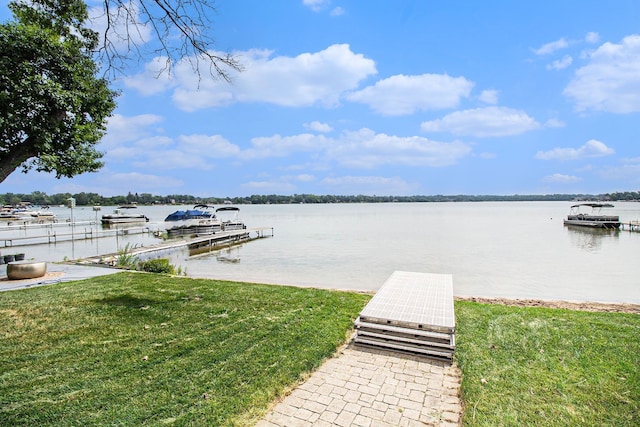 dock area featuring a water view and a yard