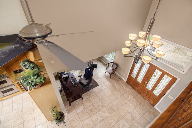 tiled foyer with a notable chandelier