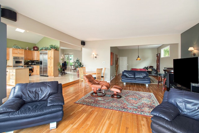 living room with lofted ceiling and light hardwood / wood-style floors