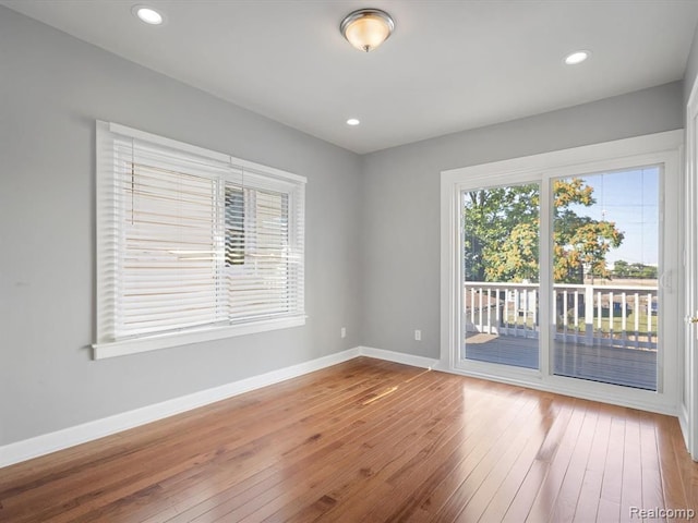 spare room with hardwood / wood-style floors