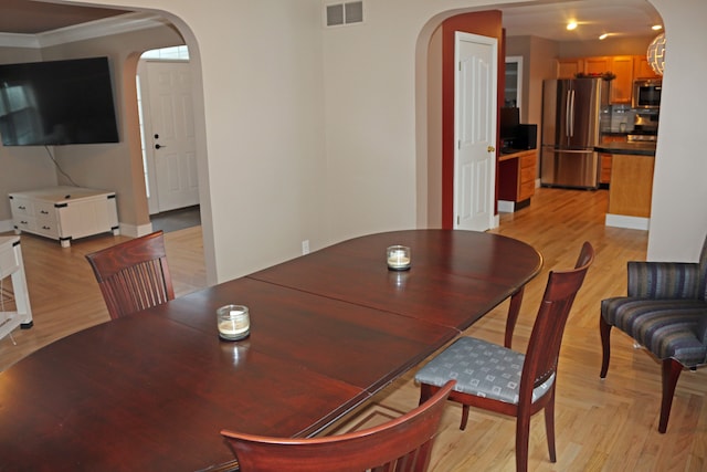 dining room featuring crown molding