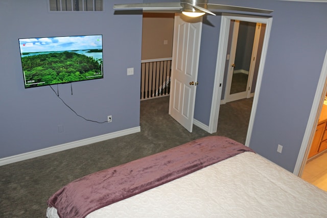 carpeted bedroom featuring ceiling fan and ensuite bathroom