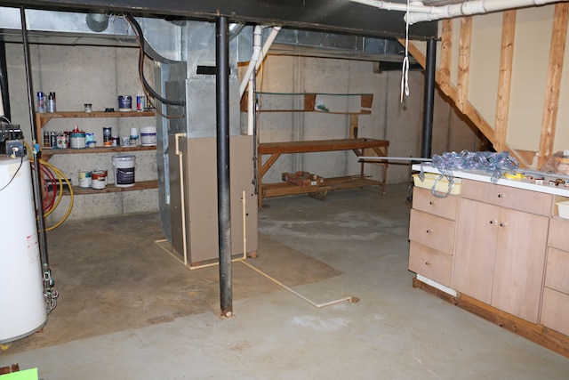 basement with water heater and heating unit