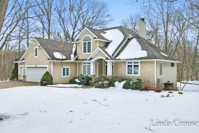 view of front of home with a garage and a chimney