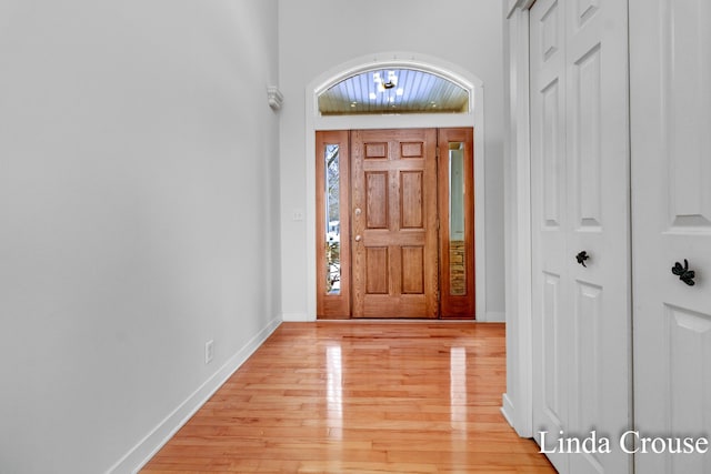 foyer entrance featuring light wood-type flooring and baseboards