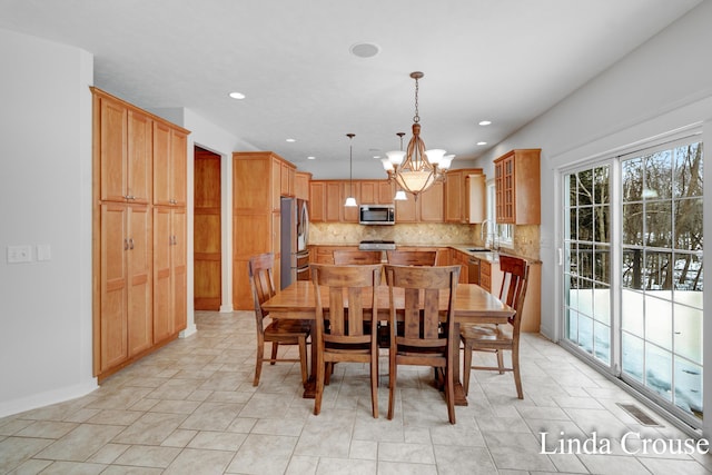 dining space with baseboards, visible vents, a notable chandelier, and recessed lighting