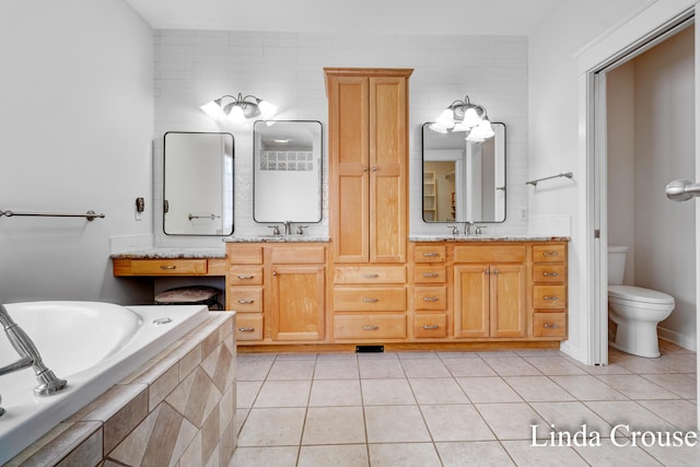 bathroom featuring toilet, a sink, a bath, and tile patterned floors