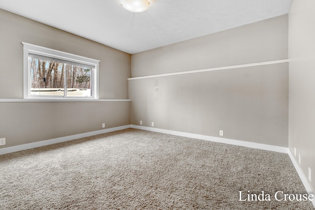 spare room with carpet flooring and baseboards