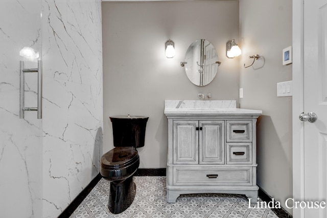 bathroom with vanity and baseboards