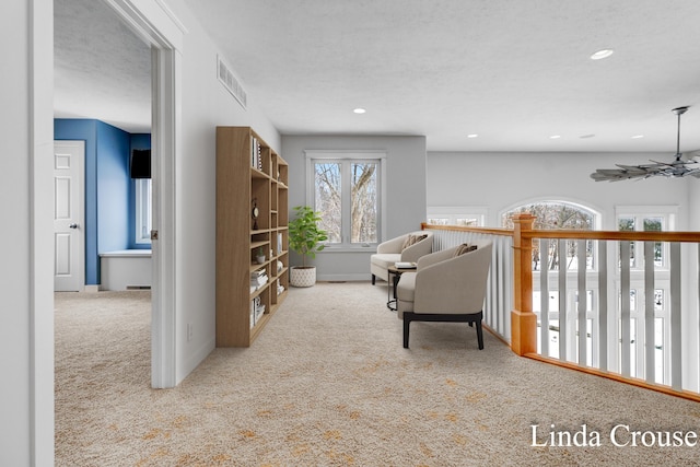 corridor with carpet floors, baseboards, visible vents, and recessed lighting