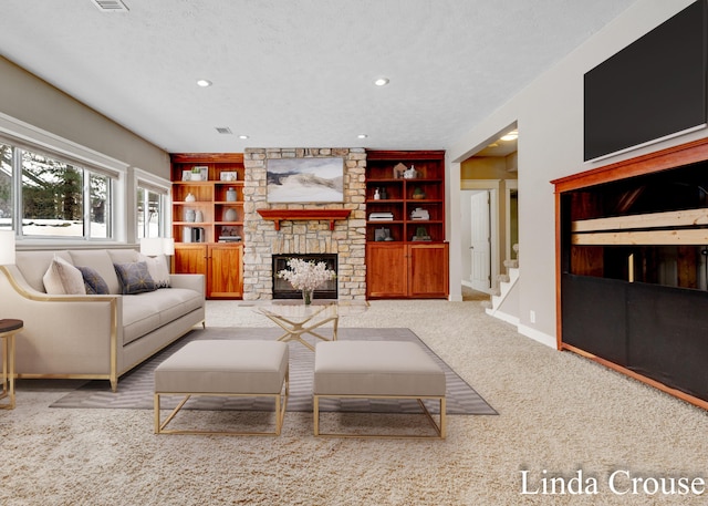 carpeted living room with baseboards, a textured ceiling, built in shelves, a fireplace, and recessed lighting