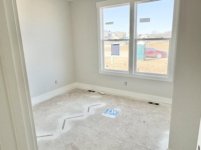 unfurnished room featuring baseboards