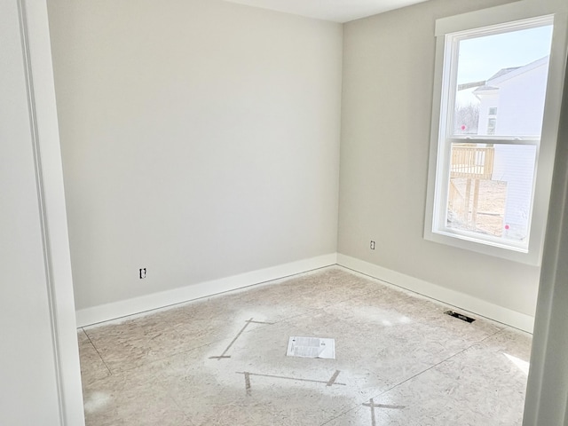 unfurnished room featuring visible vents and baseboards