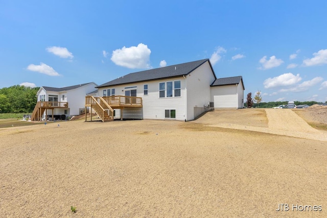 1798 Round Barn Dr, Hudsonville, MI 49426 - rear view of house featuring stairway, a wooden deck, and driveway