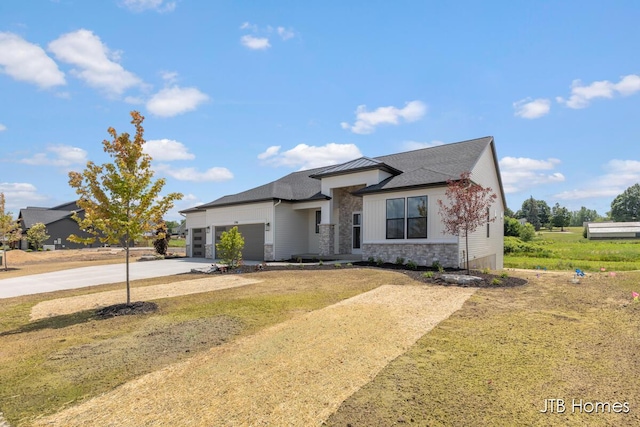 1798 Round Barn Dr, Hudsonville, MI 49426 - view of front facade with stone siding, driveway, an attached garage, and a front lawn