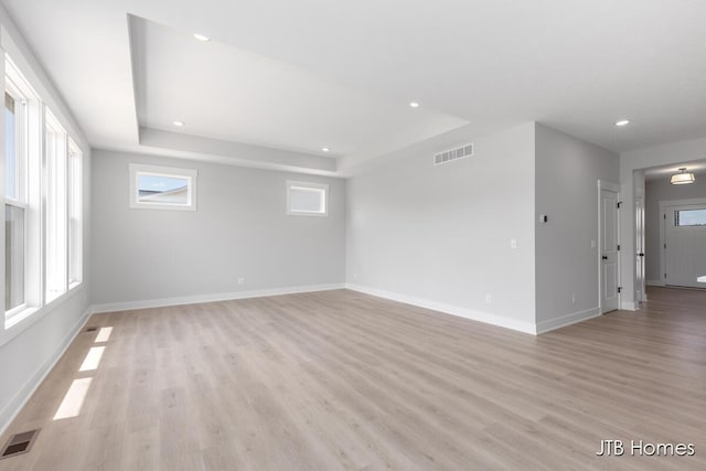 1798 Round Barn Dr, Hudsonville, MI 49426 - empty room with a raised ceiling, light wood-type flooring, and recessed lighting