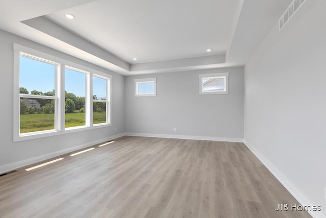 1798 Round Barn Dr, Hudsonville, MI 49426 - empty room featuring a tray ceiling, light wood-style floors, and recessed lighting