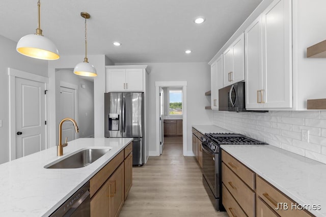 1798 Round Barn Dr, Hudsonville, MI 49426 - kitchen with stainless steel fridge, gas range oven, light wood finished floors, white cabinetry, and backsplash