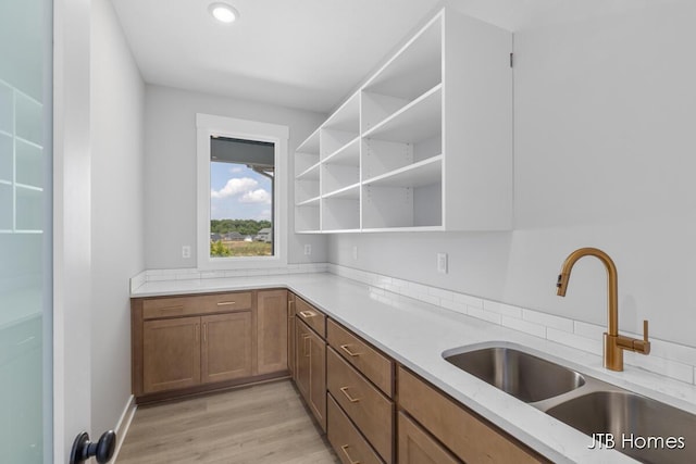1798 Round Barn Dr, Hudsonville, MI 49426 - kitchen with light stone counters, open shelves, light wood-type flooring, brown cabinets, and recessed lighting