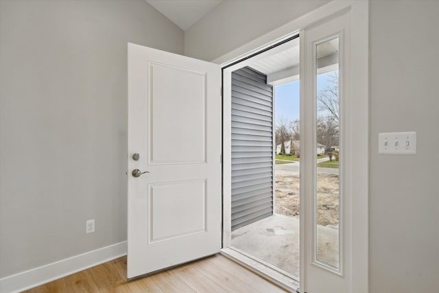 675 Crescent Lake Rd, Waterford, MI 48327 - doorway to outside with baseboards, light wood-type flooring, and lofted ceiling