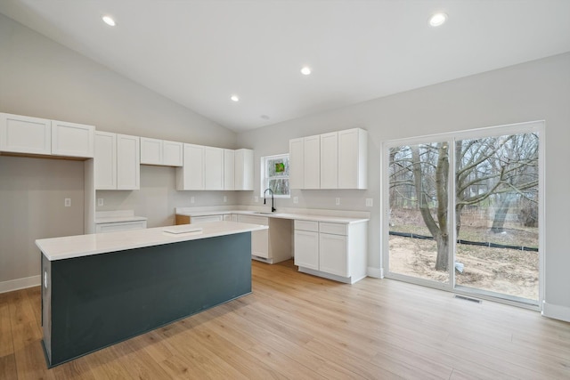 675 Crescent Lake Rd, Waterford, MI 48327 - kitchen with white cabinets, visible vents, light wood-type flooring, and a center island