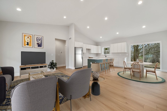 675 Crescent Lake Rd, Waterford, MI 48327 - living area featuring light wood-style floors, high vaulted ceiling, baseboards, and recessed lighting