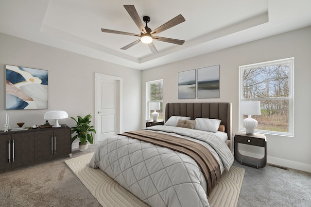 675 Crescent Lake Rd, Waterford, MI 48327 - bedroom with a raised ceiling, baseboards, a ceiling fan, and carpet flooring