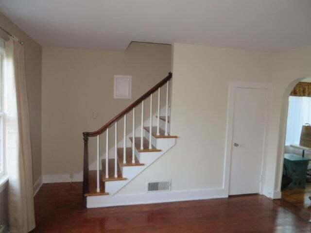 stairway with wood-type flooring and plenty of natural light