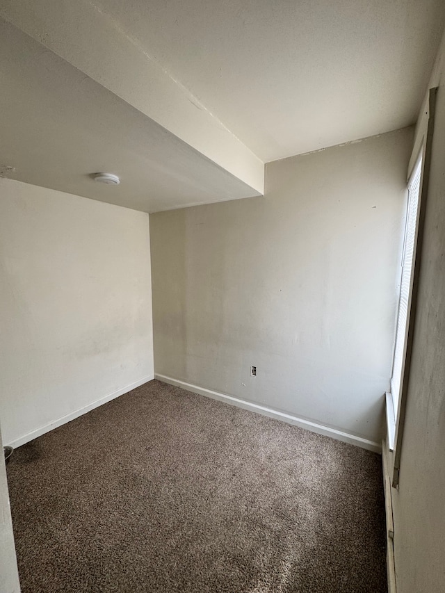 carpeted empty room with baseboards