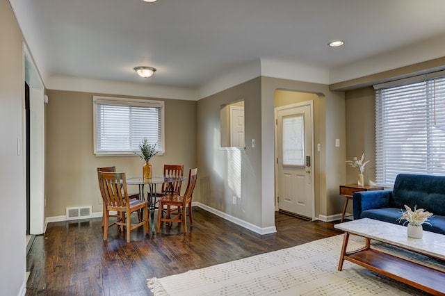 dining space featuring a healthy amount of sunlight and dark hardwood / wood-style floors