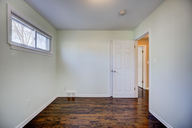 unfurnished room featuring dark wood-type flooring