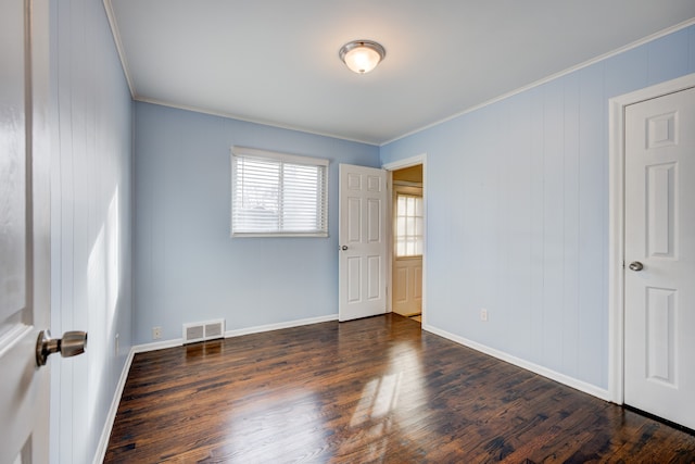 spare room with crown molding and dark hardwood / wood-style floors