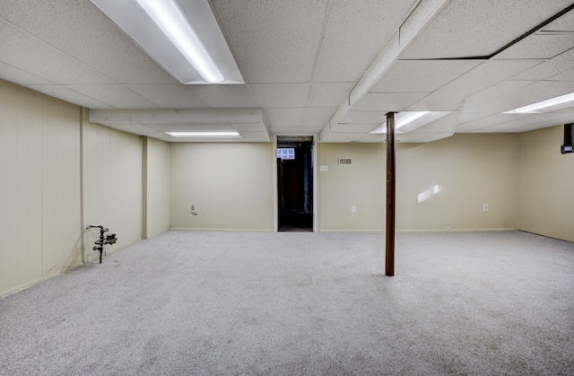 basement with carpet floors and a drop ceiling