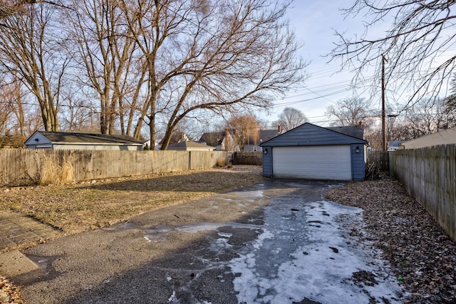 view of yard with a garage and an outbuilding