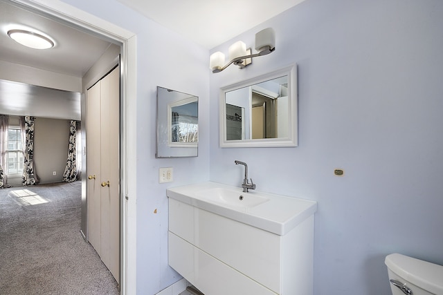 bathroom with toilet and vanity