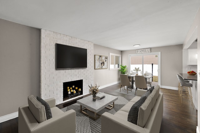 living room featuring a brick fireplace, dark wood finished floors, and baseboards