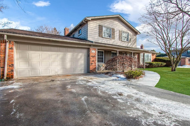 view of front property featuring a garage and a front lawn